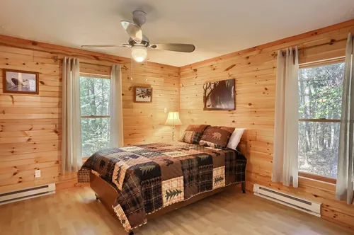 The bedroom with a queen bed and scenic views.