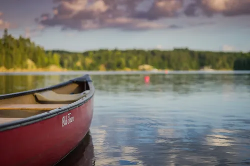 A canoe sitting on a calm river.