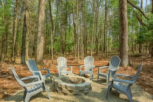 Chairs around a fire ring.