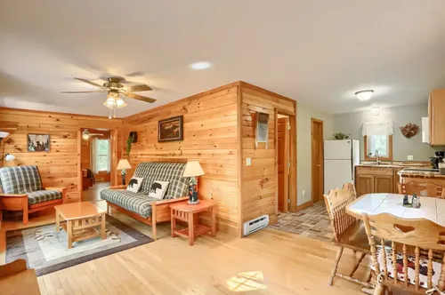 The cabin interior showing the living room, dining room, and kitchen.